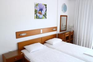 Postel nebo postele na pokoji v ubytování Danae Hotel