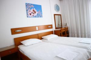 Postel nebo postele na pokoji v ubytování Danae Hotel