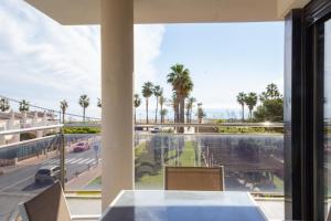 a balcony with a view of a street and palm trees at Apartamentos la Volta Aguamarina in Peñíscola