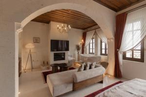 a living room with a couch and a table at Via Regia Cappadocia Hotel in Uçhisar