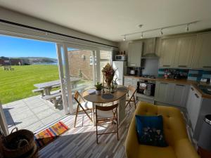 a kitchen and living room with a table and a kitchen and a patio at 187 Needles Lodge in Freshwater