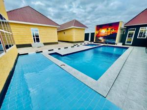 a swimming pool in front of a house at Dodoma Star Lounge in Dodoma