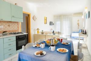 a kitchen with a table with plates of food on it at Casa Rockefeller in San Teodoro +1 photo