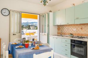 a kitchen with a table with food on it at Casa Rockefeller in San Teodoro