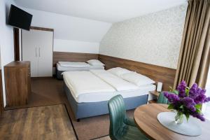 מיטה או מיטות בחדר ב-Apartmány Banff