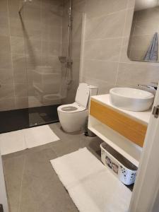 a bathroom with a toilet and a sink and a shower at Costa Vista- 2 bedroom apartment k14- kololi sands in Kololi