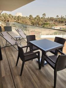 a table and chairs sitting on top of a balcony at Costa Vista- 2 bedroom apartment k14- kololi sands in Kololi +3 photos