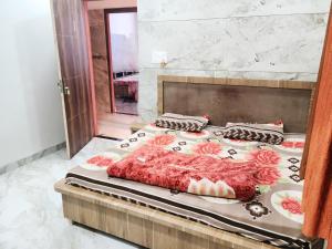 um quarto com uma cama com colcha floral em Hotel Hari Krishnashrya em Vrindavan