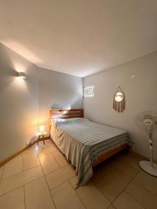 Un dormitorio con una cama y una lámpara. en Appartement 2 chambres avec Jardin privé sur la côte Nord, en Calodyne