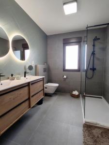 a bathroom with a sink and a shower and a toilet at Boutique Beach House, Colina del Emperador in La Manga del Mar Menor +55 photos