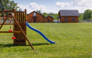 a playground with a blue slide in a field at Awesome Home In Bilje With Outdoor Swimming Pool in Bilje