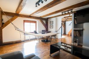 a hammock in the living room of a house at Roof Apartment in Wrocław