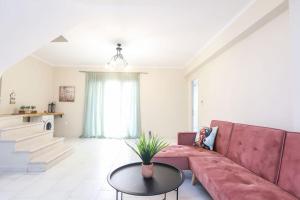 a living room with a red couch and a table at Elite Villas, Corfu in Áno Korakiána +138 photos