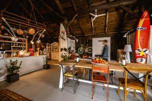 a kitchen with a wooden table and a surfboard at Siedlisko Blanki in Suryty