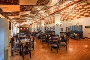 a restaurant with wooden floors and tables and chairs at Grand View Hotel in Dalhousie
