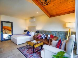 a living room with a couch and a bed at The Pine Court Luxury Resort in Bhurban