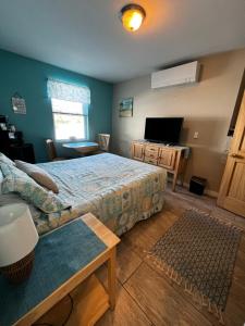 a bedroom with a bed and a tv and a couch at Pine View Lodge Old Orchard Beach in Old Orchard Beach