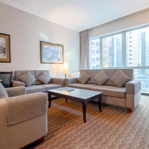 a living room with a couch and a table at Al Manzel Hotel Apartments in Abu Dhabi