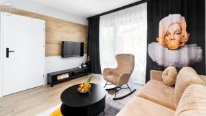 Televízia a/alebo spoločenská miestnosť v ubytovaní Apartamenty Good Time- Stone Hill II