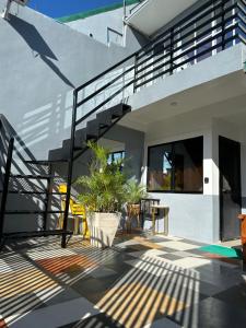 a house with stairs and a patio with a plant at Tacloban EVMC Gdex Transient House in Tacloban
