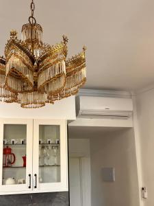 a chandelier hanging from a ceiling in a room at Soñar en la Plaza Cervantes 1 in Alcalá de Henares +22 photos