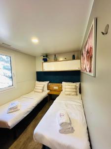 a room with two beds and a window at Lucija Mobile Home in Biograd na Moru