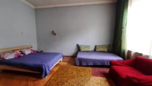 a room with two beds and a couch in it at APARTMENTS on SHOLOM ALEICHEM та ще варіант поруч in Lviv