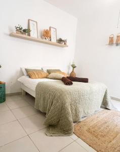 a bedroom with a bed with a blanket on it at Top location Sliema stylish rooms in Sliema