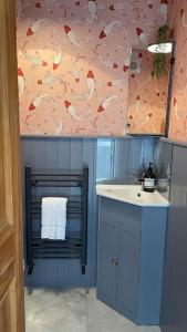 a bathroom with a sink and a counter with a towel at Brunswick Townhouse in Penrith +15 photos