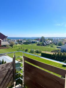 a view from the balcony of a house with a fence at Angelika in Swarzewo