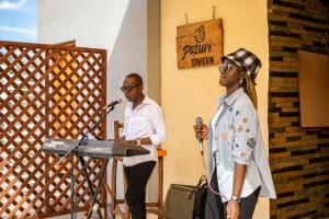 two men standing at a podium with a microphone at Inkaba Resort & Conference Centre Kilifi in Kilifi