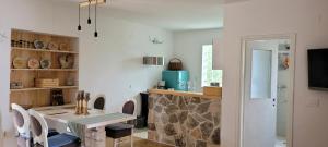 a dining room with a table and some chairs at PomaloVilla at Gradina Cove in Vela Luka