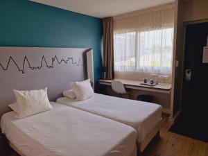 Letto o letti in una camera di Kyriad Carcassonne - Aéroport