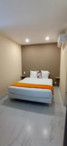 a bedroom with a bed in a room at Les Sables Blancs de la Liscia in Calcatoggio