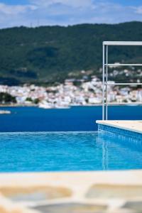 a swimming pool with a view of the water at Villa Lazareta in Punta