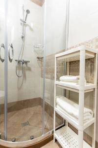 a bathroom with a shower with a glass shower stall at Bissera premium apartments in Sofia +71 photos