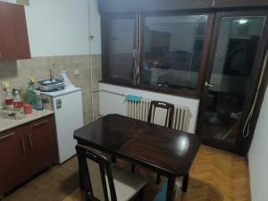a kitchen with a wooden table and a table and chairs at Stan na dan in Valjevo