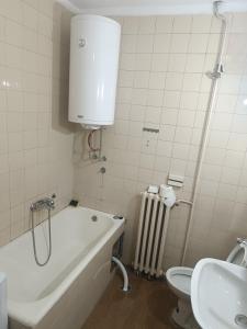 a bathroom with a tub and a toilet and a sink at Stan na dan in Valjevo