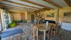 a dining room with a table and chairs at Dom pod Modrzewiem in Świątki