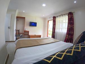 Mayas Suites客房内的一张或多张床位