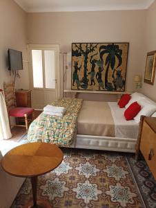 a bedroom with a bed and a table and a rug at Marianna in Isnello