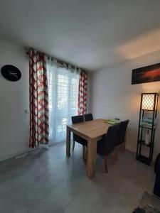 a dining room with a wooden table and chairs at Appartement d'une chambre avec vue sur la ville terrasse amenagee et wifi a Saint Germain en Laye in Saint-Germain-en-Laye
