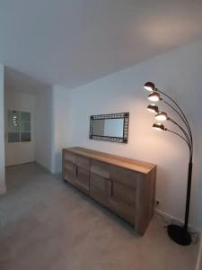 a living room with a desk and a lamp at Appartement d'une chambre avec vue sur la ville terrasse amenagee et wifi a Saint Germain en Laye in Saint-Germain-en-Laye
