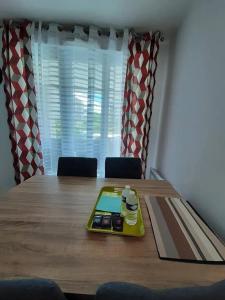 a dining room table with a tray of food on it at Appartement d'une chambre avec vue sur la ville terrasse amenagee et wifi a Saint Germain en Laye in Saint-Germain-en-Laye