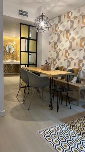 a dining room with a wooden table and chairs at Aparthotel Boutique Poniente Playa in San Antonio