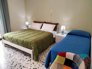 a bedroom with two beds and two lamps at La Castellina 23 in Sulmona