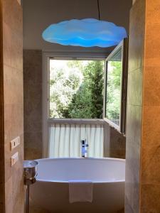 a large bath tub in a bathroom with a window at Florence Art Apartments in Florence