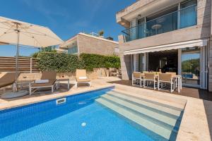 a villa with a swimming pool and a house at Villa Camelia ZadarVillas in Petrcane