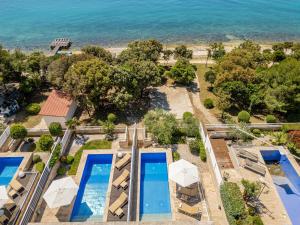 an aerial view of a resort with two swimming pools at Villa Camelia ZadarVillas in Petrcane