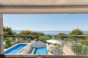 a view of the pool from the balcony of a house at Villa Camelia ZadarVillas in Petrcane